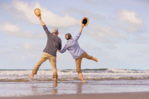 middle age couple dancing on the shoreline