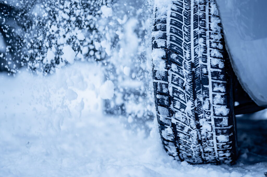 up close view of car tire on snowy road