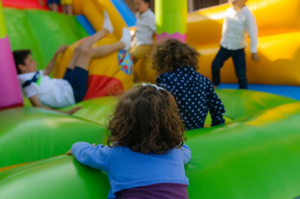 Children playing inside a bounce house representing personal liability coverage for homeowners